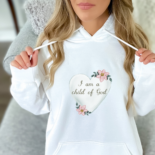 Discover comfort and faith in our "Child of God" hoodie. Made with 50% cotton and 50% polyester, it offers durability and coziness. Featuring the empowering message "I am a child of God" and John 1:12 verse, it's a wardrobe staple. Ethically made with 100% US-grown cotton. Available in various sizes and colors. Wear your faith proudly.