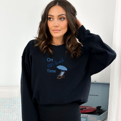 A woman  wearing a stylish black sweatshirt with a touch of the sea turtle design